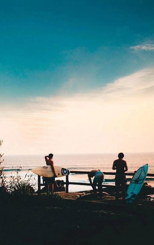 Surfers getting ready to surf at sunset near Nicaragua Surf Camp in Popoyo, Tola.