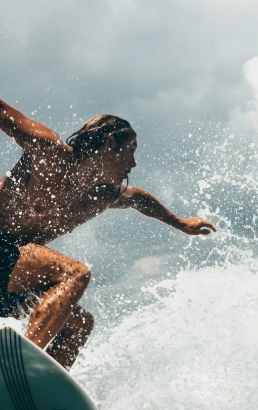 A surfer carving through a wave under cloudy skies, representing the Nicaragua Surf Guide.