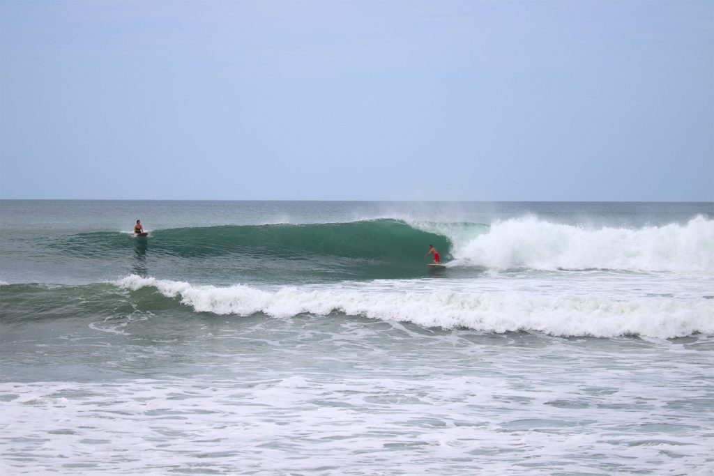 surf-coach-giving-real-time-feedback-to-a-beginner-surfer-during-a-lesson-at-Nicaragua-Surf-Camp